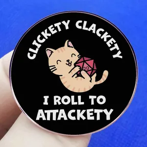 Orange cat holding D20 dice pin badge with Clickety Clackety I Roll To Attackety text