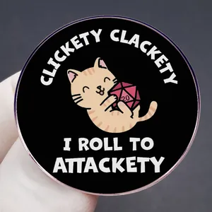Orange tabby cat holding a d20 die enamel pin with Clickety Clackety text on black background