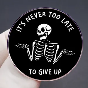 Enamel skull brooch with satirical IT'S NEVER TOO LATE TO GIVE UP slogan for outfits