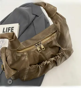 Detail shot of smooth double metal zippers and retro pleated leather texture