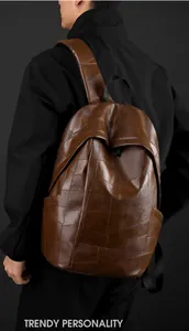 Detail of dark brown PU leather backpack featuring irregular square patchwork design