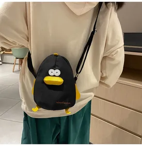 Detail of cartoon duck canvas crossbody bag featuring 3D beak and yellow feet accents