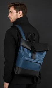 Close-up of waterproof business backpack with side-view on model in dark tones
