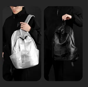 Detailed view of large PU leather backpack with geometric patchwork in silver and black