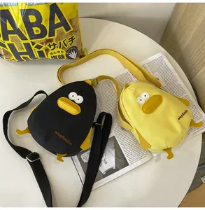 Detail of cute yellow and black canvas duck crossbody bags with adjustable straps
