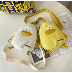 Detail of cute yellow and white canvas duck crossbody bags with 3D wings and feet
