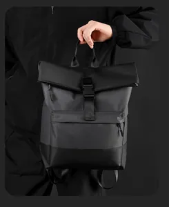 Detail of waterproof black business backpack featuring roll-top closure and matte texture