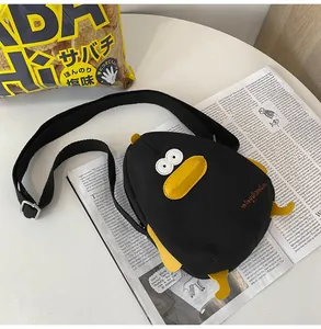 Detail of cartoon duck canvas bag showing high-quality embroidery and adjustable strap