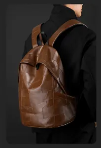 Brown PU leather backpack with geometric patchwork design worn by a male model