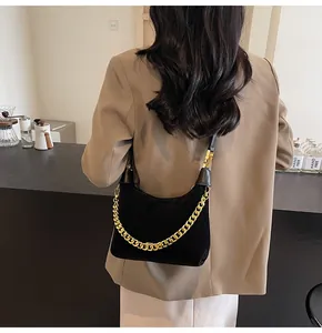 Detail of black crescent hobo bag with chunky gold chain strap for women fashion