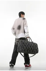 Détail du grand sac de voyage matelassé avec bords effilochés et doubles poignées
