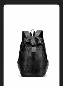 Front view of black patchwork leather backpack with textured stitching and mesh straps