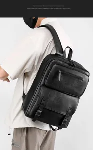 Detail of the high-quality black litchi grain leather texture on a business backpack