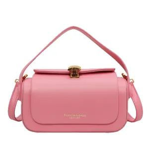 Pink leather shoulder bag with golden shell lock and adjustable strap for women