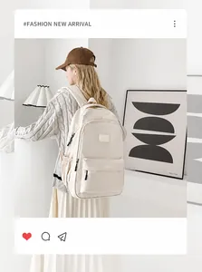 Detailed view of cream-colored backpack with large main compartment and black zippers