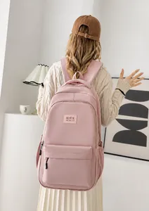 Pink minimalist backpack featuring large capacity and waterproof fabric shown in detail