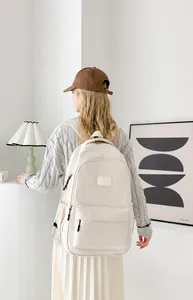 Lifestyle view of a cream-colored large capacity backpack in a modern interior setting