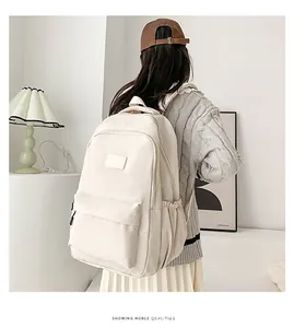 Lifestyle shot of a minimalist cream nylon backpack worn in a cozy home setting
