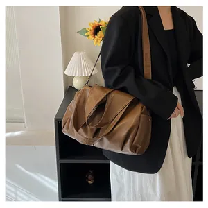 Détail du grand sac cabas en cuir marron avec plis naturels et large bandoulière