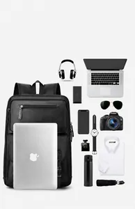 Flat lay of large capacity black leather backpack with organized tech gear and laptop