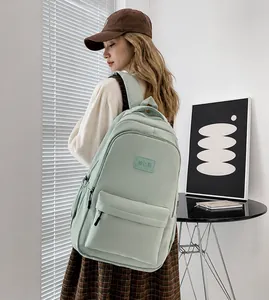 Mint green large capacity laptop backpack shown in a modern lifestyle setting