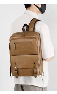 Rear view of man wearing a large brown vintage PU leather backpack with multiple pockets