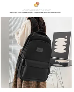 Modern black waterproof nylon backpack for daily commute and students on a model
