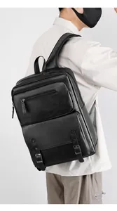 Detail of black waterproof business backpack featuring lychee texture and metal buckles