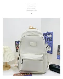Minimalist white large capacity backpack shown in a modern lifestyle room setting