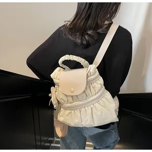 Creamy white pleated backpack for women showing back view with stylish hanging pouch