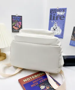 Close-up of the white quilted puffer backpack with soft padded waterproof material