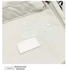 Close-up of waterproof fabric on cream backpack showing water beads on surface