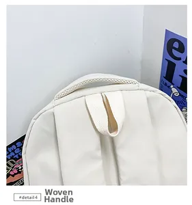 Detailed macro view of the cream woven top handle and breathable mesh of the backpack