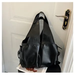 Détail du sac cabas noir en cuir PU à texture grainée avec fermeture éclair latérale