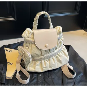 Detail of stylish pleated nylon backpack with a matching round coin purse accessory