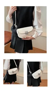 Detail of vintage saddle bag featuring white leather and beige woven fabric texture