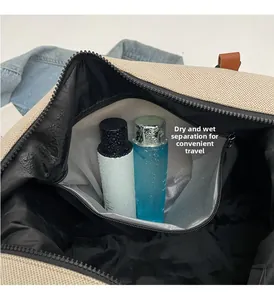 Detail view of the dry-wet separation waterproof compartment in a beige travel bag