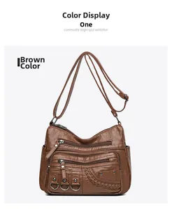 Dettaglio frontale della borsa a tracolla marrone in ecopelle con tasche multiple zip