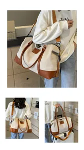 Detail of large canvas travel bag with leather straps and adjustable shoulder strap