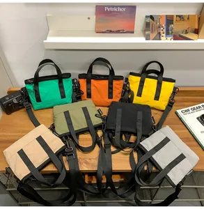 Detailed close-up of colorful nylon handbags with adjustable straps on a wooden table
