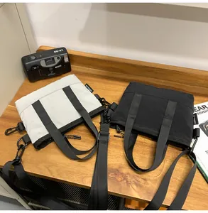 Detail of lightweight nylon commuter bags in grey and black with adjustable straps
