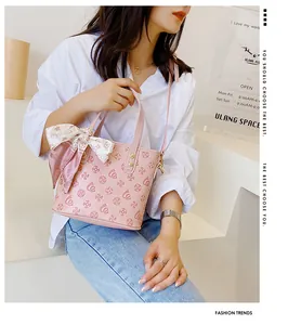 Rosa gemusterte Mini-Eimertasche mit Seidenschal-Detail an einem weiblichen Model
