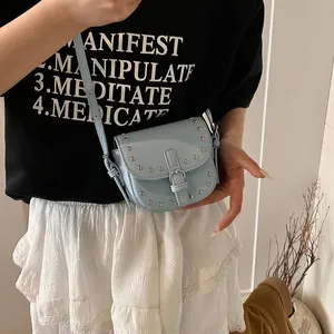 Light blue mini studded saddle bag with silver rivets and adjustable shoulder strap