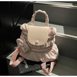 Detail of light pink ruffled nylon backpack with ribbon bow and matching round coin purse