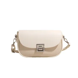 Minimalist saddle bag with beige canvas fabric and cream leather flap in a modern design