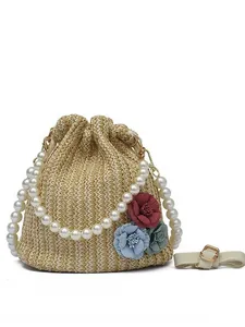 Straw bucket bag with floral decor and pearl handle for summer beach vacation