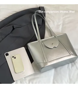 Silver tote bag size comparison showing capacity with an iPad and a smartphone