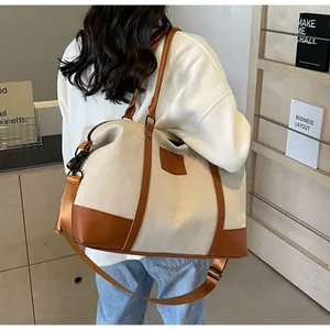 Detail of canvas travel bag with leather trim and adjustable shoulder strap for yoga
