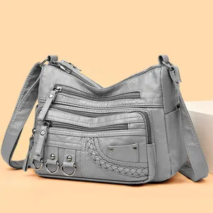 Gray washed faux leather shoulder bag with multi-pocket design and metallic ring details