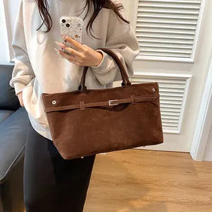 Retro brown frosted leather tote bag with buckle detail and large capacity shown by model